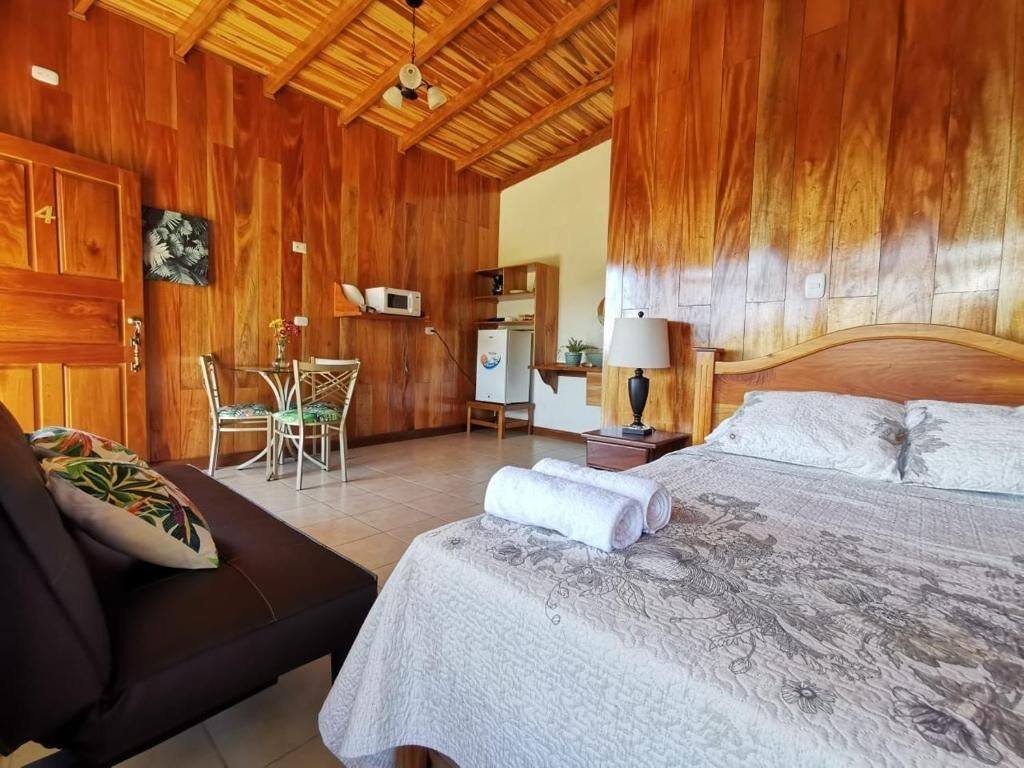 Wood-finished studio with bed, sofa and desk